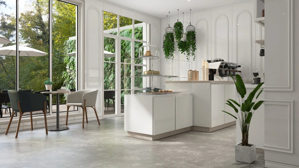 Modern, luxury design cafe, corrugated counter with espresso machine, cabinet, shelf, coffee table, chair in sunlight from glass window by garden on white wainscot wall and cement floor